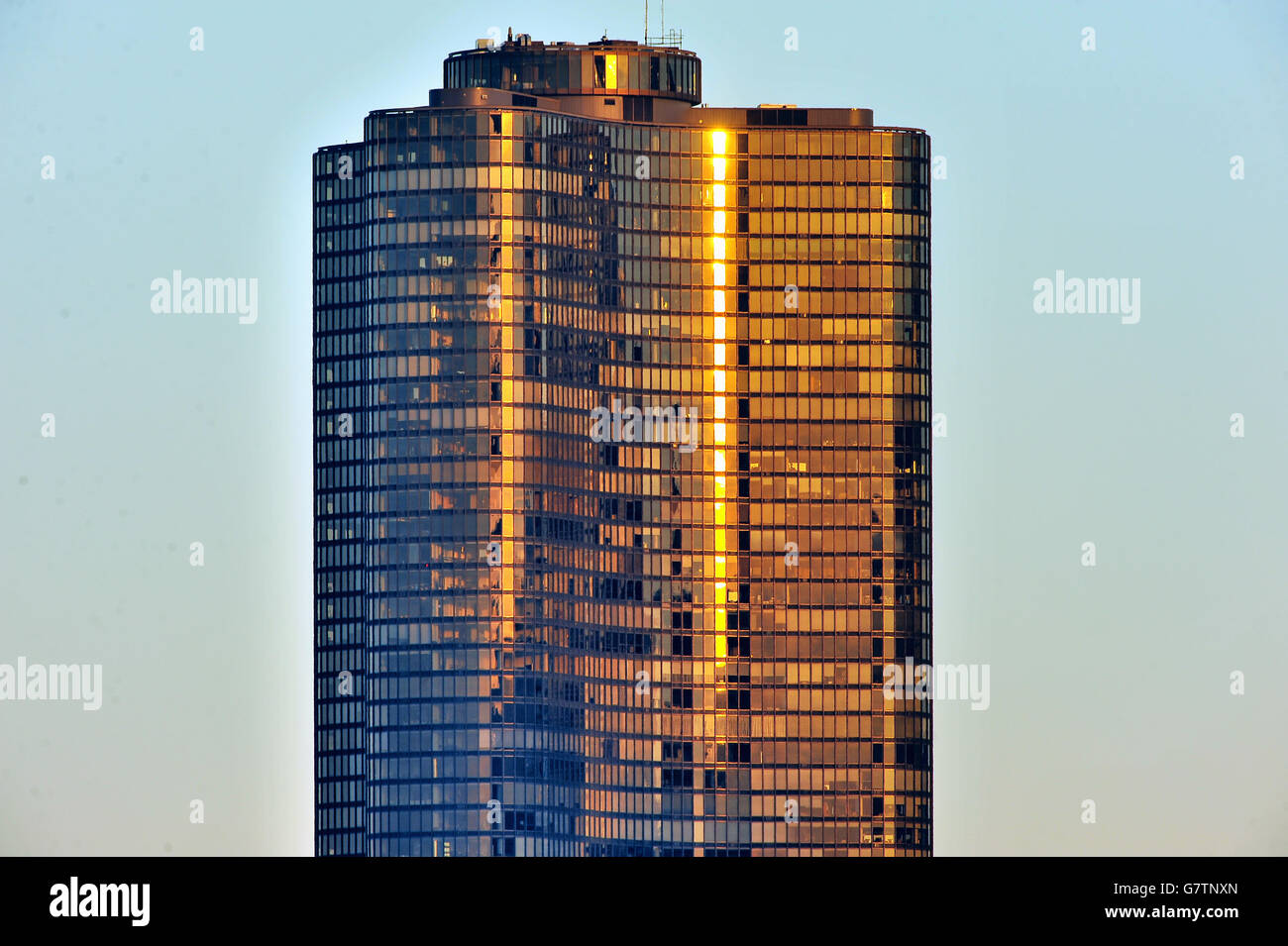 The top floors of the luxury residential building, Chicago's Lake Point Tower, reflecting the light from the setting sun. Stock Photo
