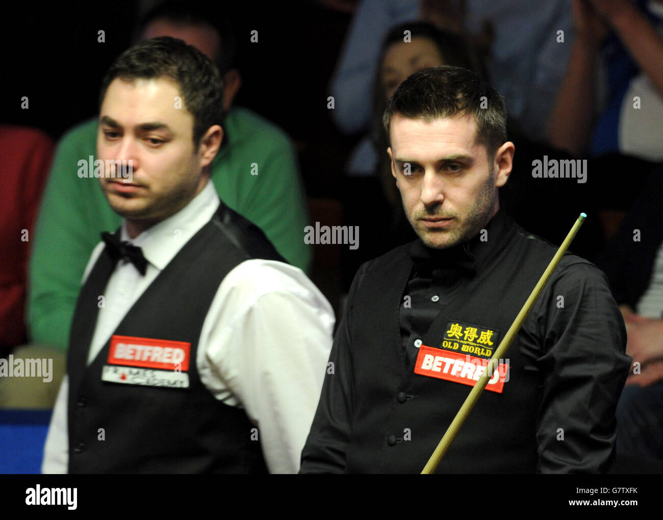 Mark Selby (right) during his match against Kurt Maflin during the Betfred World Championships at the Crucible Theatre, Sheffield. Stock Photo