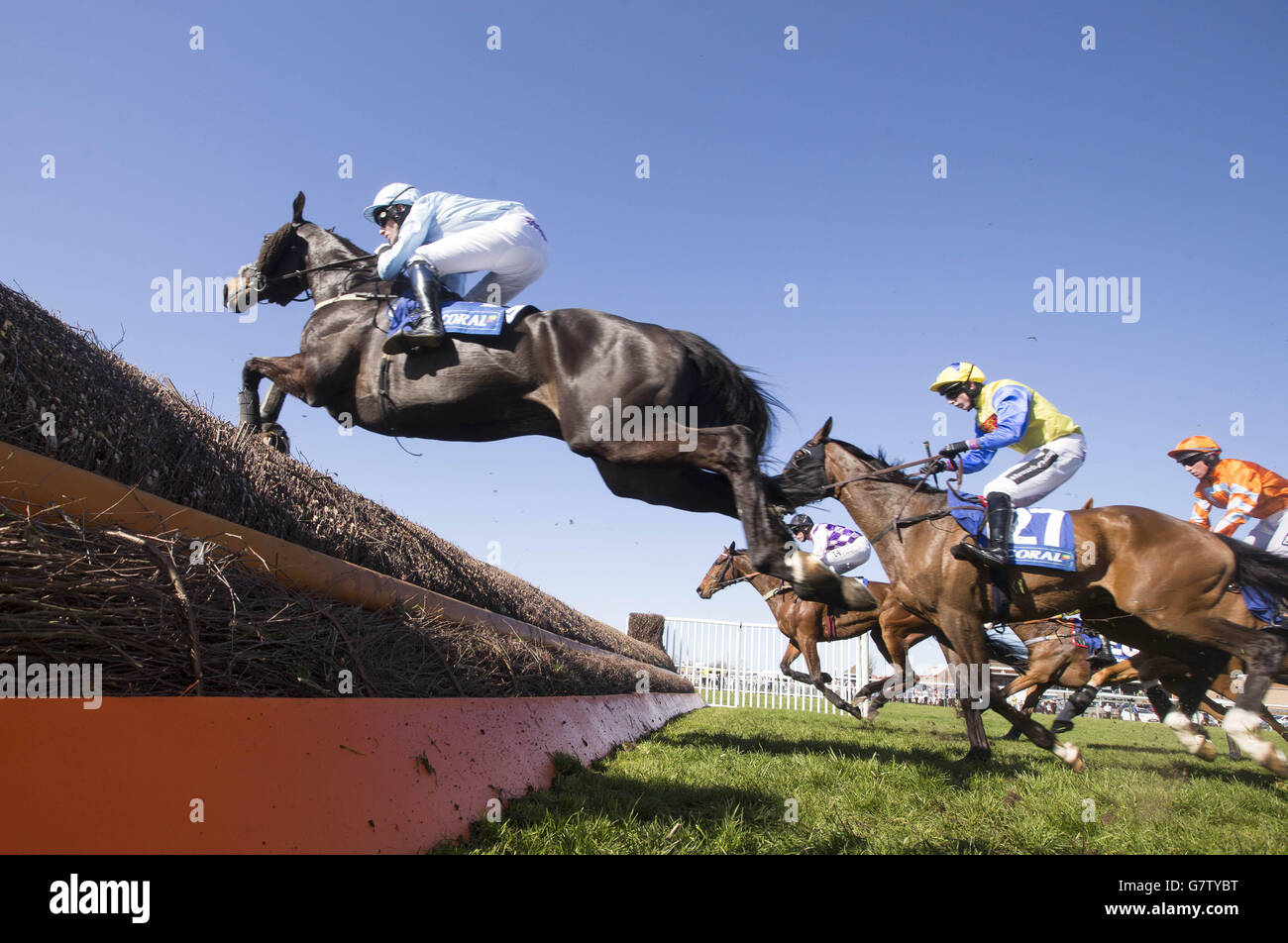Cape Tribulation ridden by Brian Hughes (left) and Amigo ridden by Conor O'Farrell right during The Coral Scottish Grand National Handicap Chase during the 2015 Coral Scottish Grand National Festival at Ayr Racecourse. Stock Photo