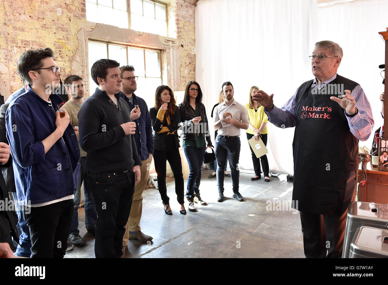 Former Maker's Mark president Bill Samuels Junior talks to visitors about the rising popularity of bourbon in the UK during a visit to the Jim Beam Crafthouse in London, which has opened to mark the rise in popularity of bourbon in the UK. Stock Photo