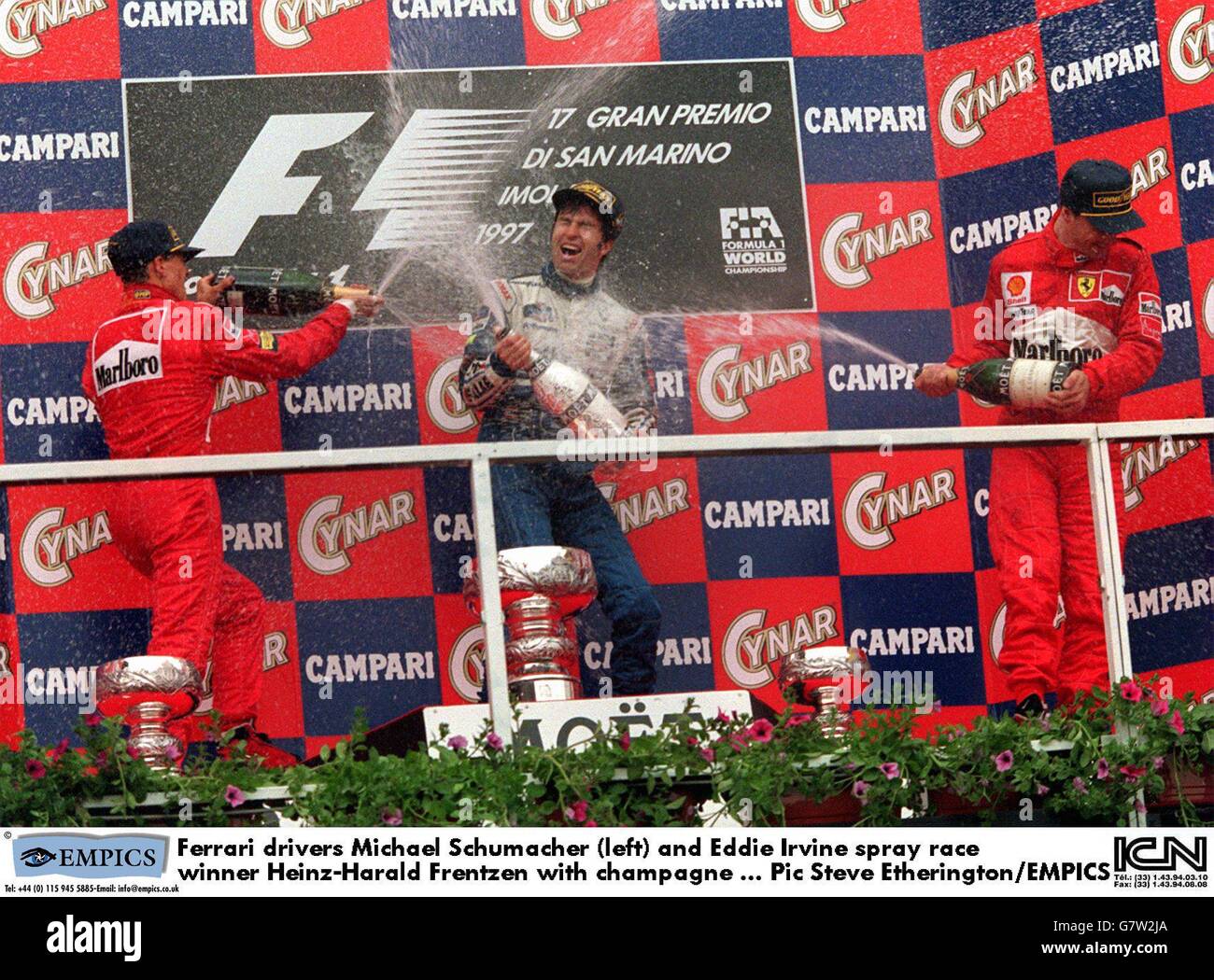Ferrari drivers Michael Schumacher (left) and Eddie Irvine spray race