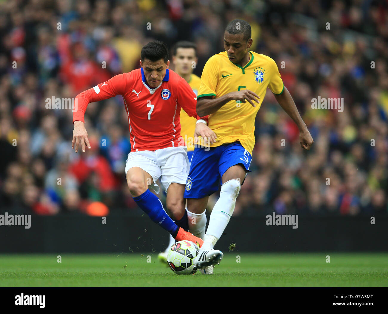 Brazil's Fernandinho (right) and Chile's Alexis Sanchez battle for the ball. Stock Photo