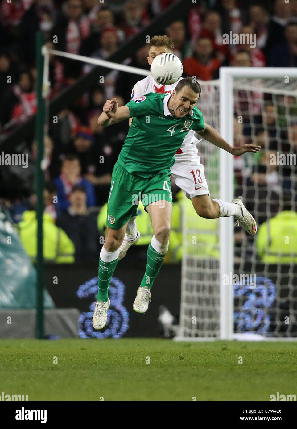 Republic of Ireland's John O'Shea (front) and Poland's Maciej Rybus battle for the ball during the UEFA Euro 2016 Qualifier at the Aviva Stadium, Dublin, Ireland. Stock Photo