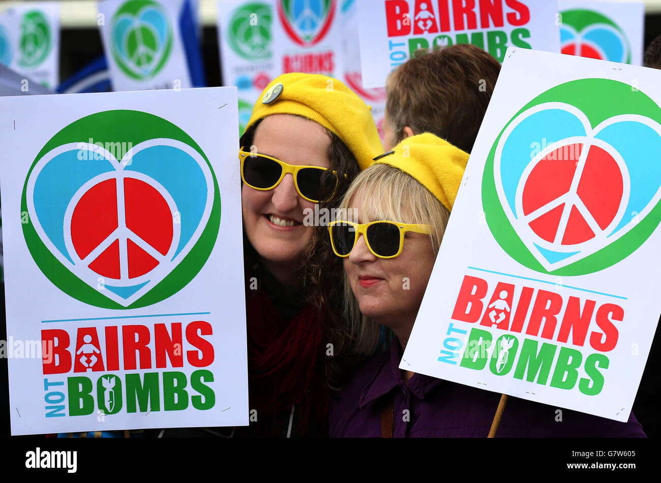 Demonstrators holding placards as they attend a rally organised by the Scrap Trident group in George Square, Glasgow. Stock Photo