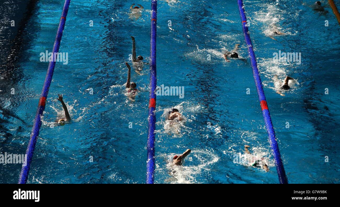 The competitors warm up in the pool before the start of the morning