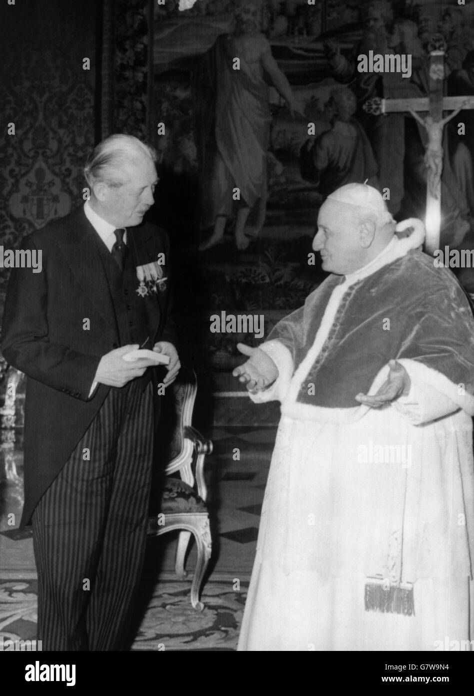 Wearing medals, British Prime Minister Harold MacMillan pictured when he was warmly welcomed by Pope John at Vatican City. The Premier, who conferred with the Pope in French, was accompanied by Lord Home, Foreign Secretary, and Sir Thomas Scarlett, the British Minister to the Holy See, The Premier is currently in Rome for talks with the Italian Government. Stock Photo