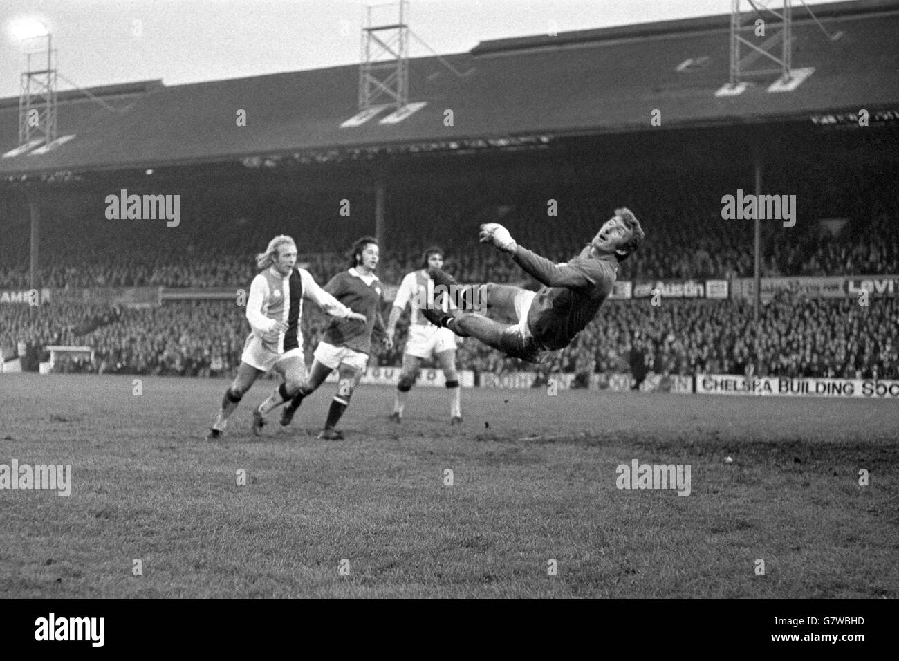 Crystal Palace's Alan Whittle (l) and John Hughes (second r), and Manchester United's Tony Young (second l), look on as Manchester United goalkeeper Alex Stepney (r) is beaten by Palace's second goal Stock Photo