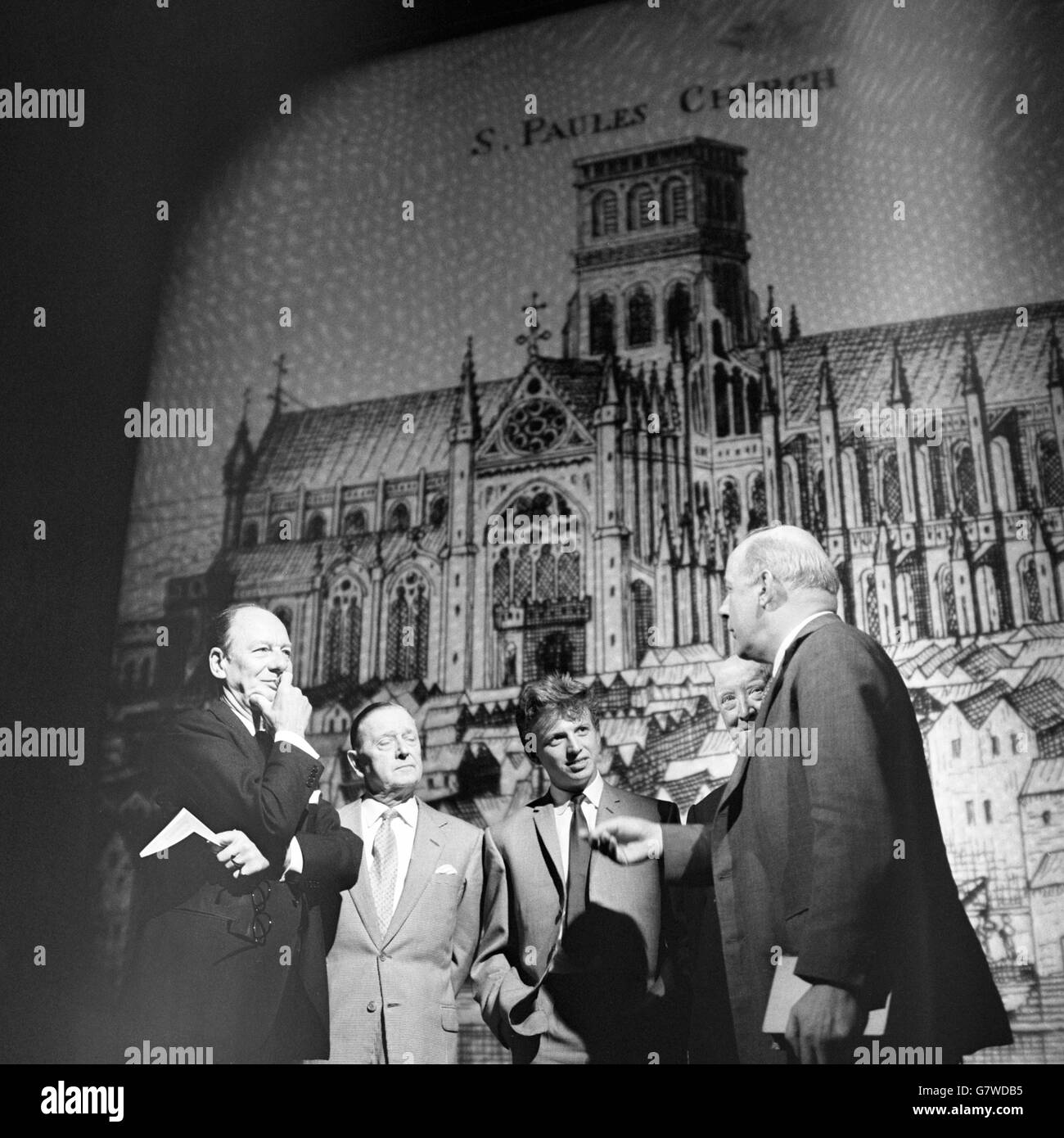 The entertainment to be given when the Queen attends a City of London Festival reception on July 9 is discussed by some of the participants at the Prince's Theatre, London. Left to right - SIR JOHN GIELGUD: RANDOLPH SUTTON: TOMMY STEELE: BILLY DANVERS: and JOHN BETJEMAN. They are talking in front of a projected drawing of St. Paul's Cathedral as it was before the Great Fire. Projections such as this will form the background when John Betjeman and Sir John give a series of prose and verse readings. Stock Photo