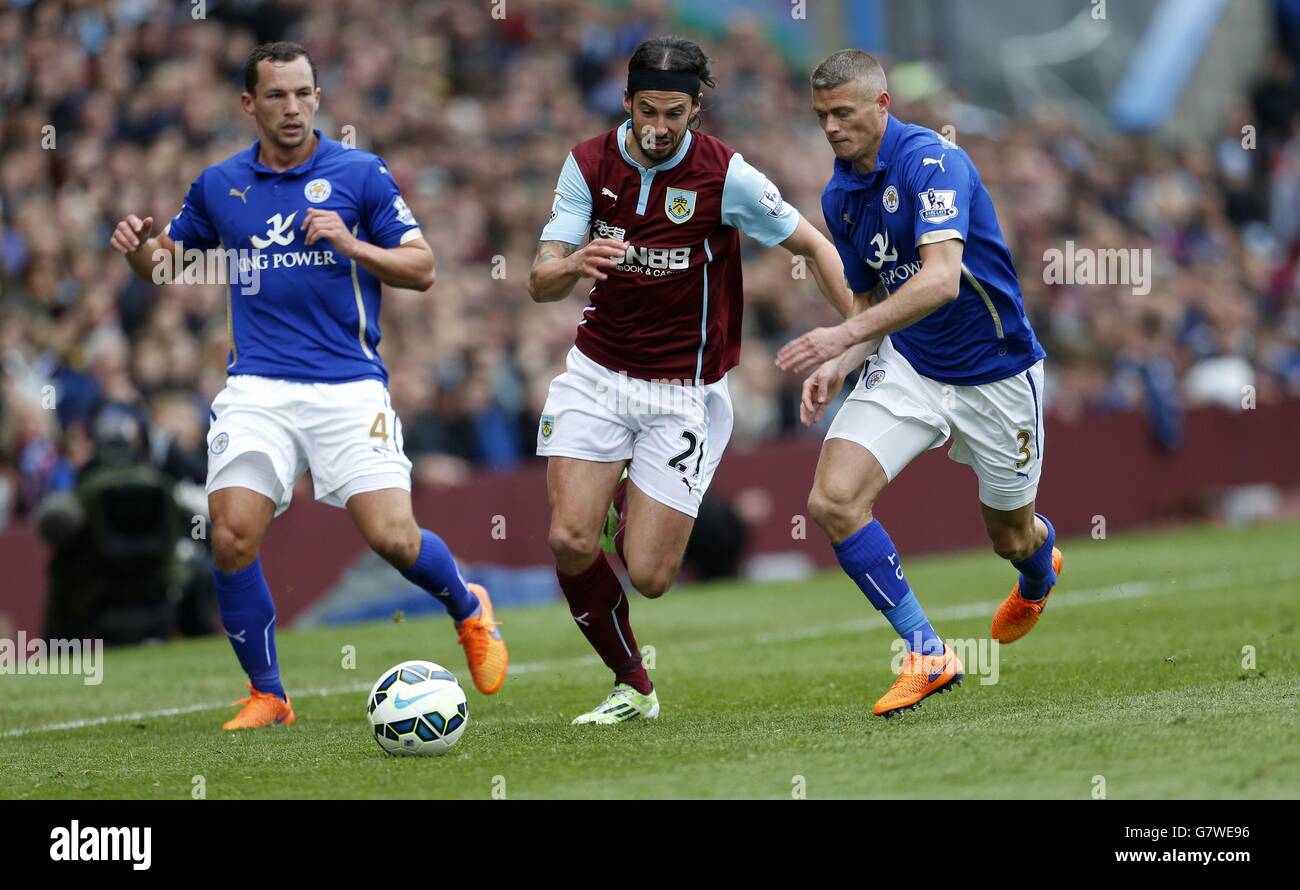 Burnley's George Boyd battle for the ball with Leicester City's Danny Drinkwater and Paul Konchesky (right) during the Barclays Premier League match at Turf Moor, Burnley. Stock Photo