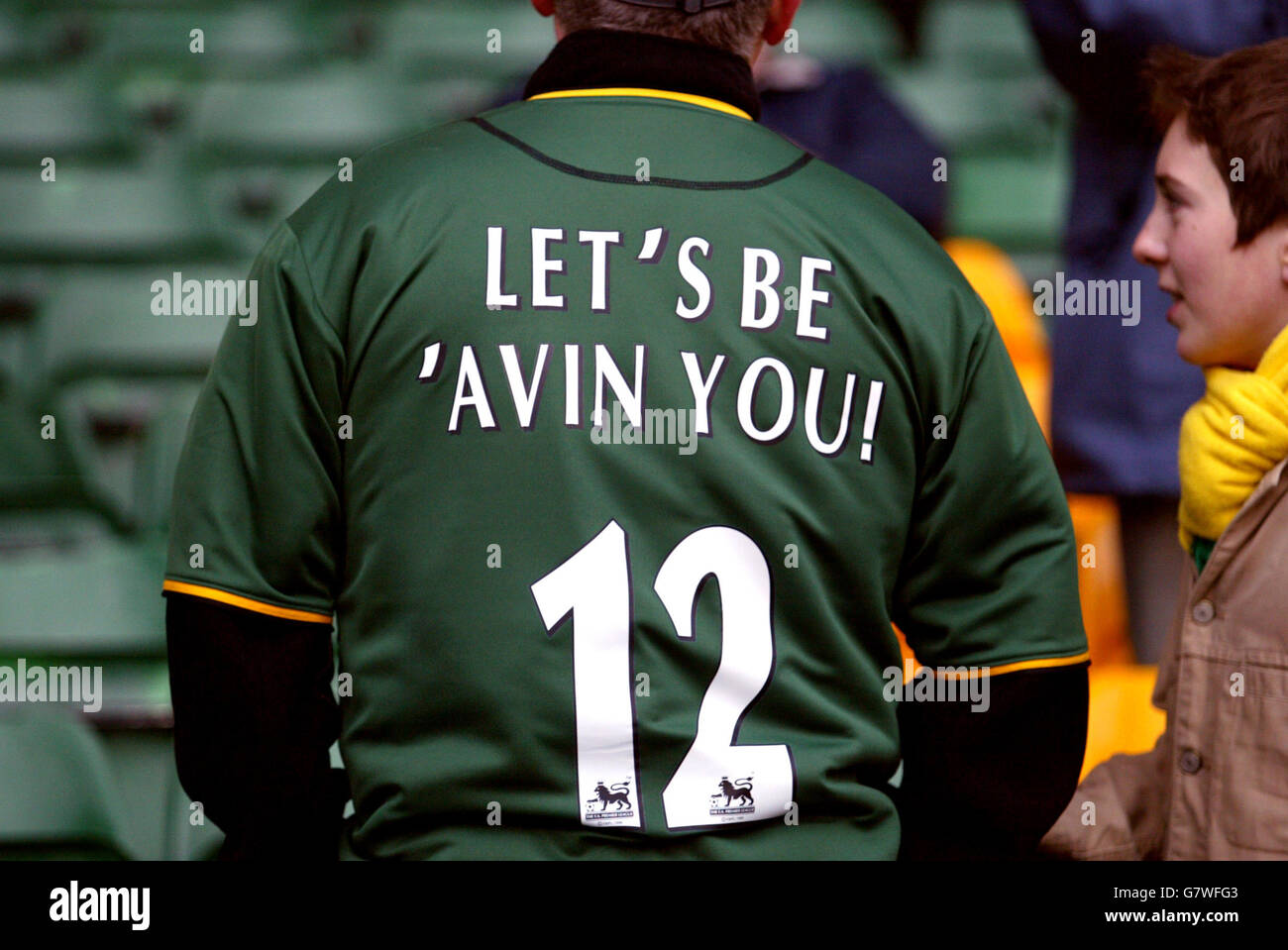 A Norwich fan with 'Lets be avin you!' on his shirt after Norwich City's director Delia Smith comments on the pitch earlier in the week Stock Photo