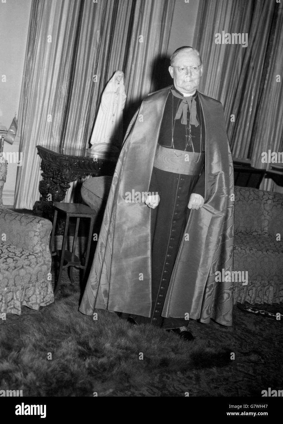 Pictured as his residence, Archbishop's House, Westminster, London, is Dr. William Godfrey, Roman Catholic Archbishop of Westminster, one of 23 new Cardinals announced in Rome. 69 year old Dr. Godfrey was born in Liverpool and was ordained in 1916. Shortly before the last war, he was appointed Apostolic Delegate in Britain, the first resident papal envoy in this country since the reformation. In 1953, Dr. Godfrey became Archbishop of Westminster after the death of Cardinal Griffin in 1956. Stock Photo