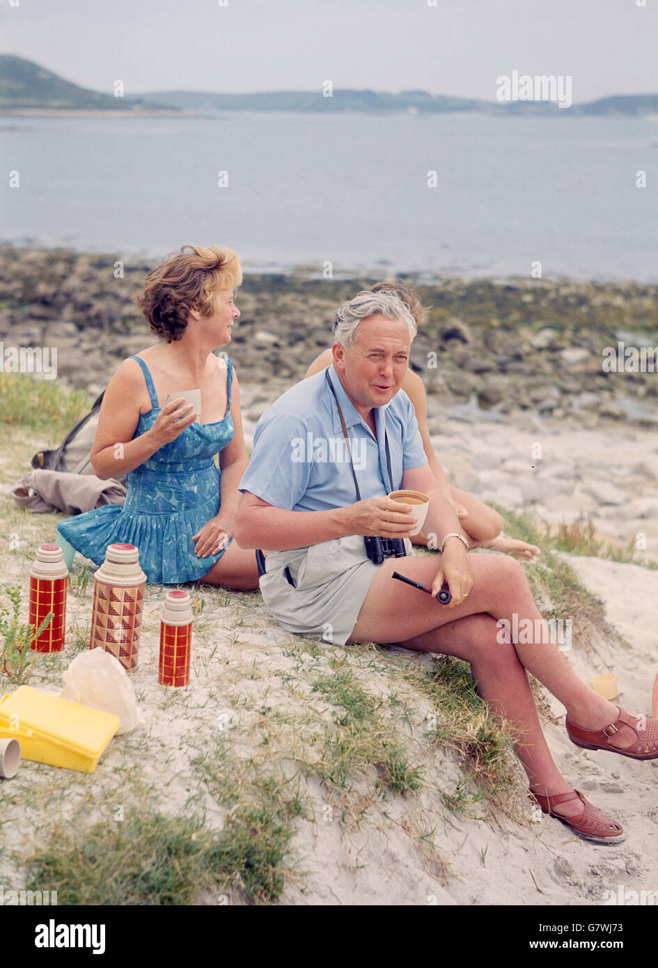 Prime Minister Harold Wilson, wearing a shirt and shorts, pictured with his wife Mary during their summer holiday in the Isles of Scilly. Stock Photo