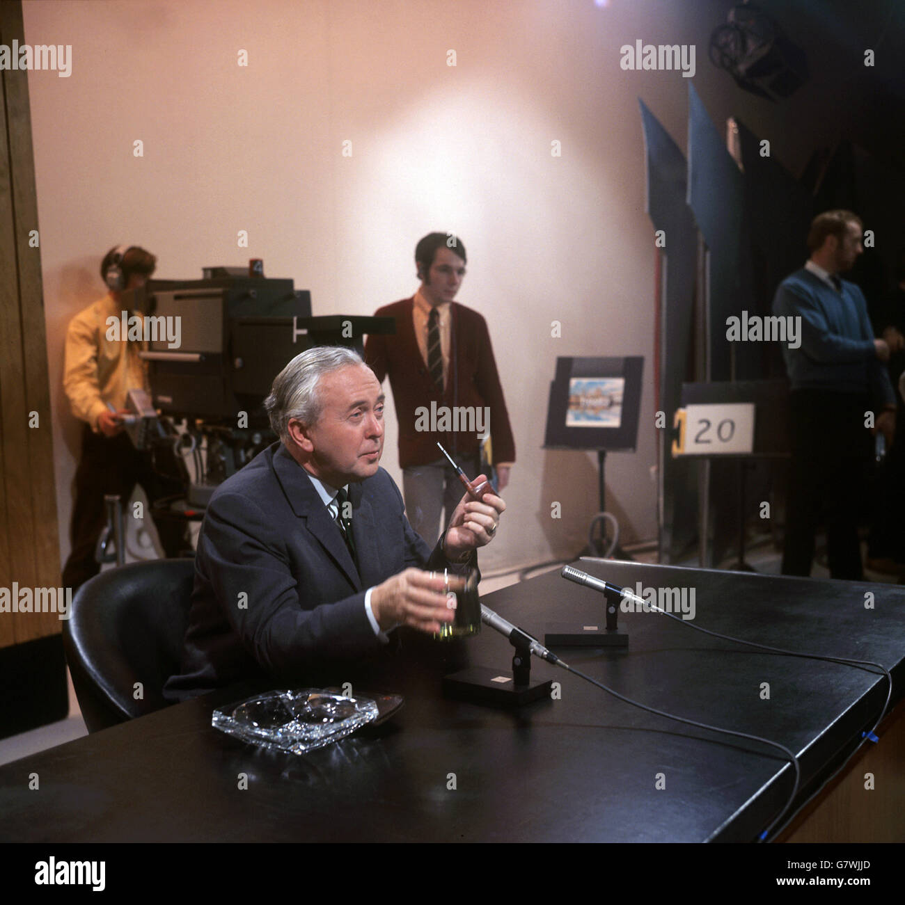 Prime Minister Harold Wilson sits at a desk smoking a pipe during filming for the 'This Week' programme filmed at Thames Television's Studio in London Stock Photo