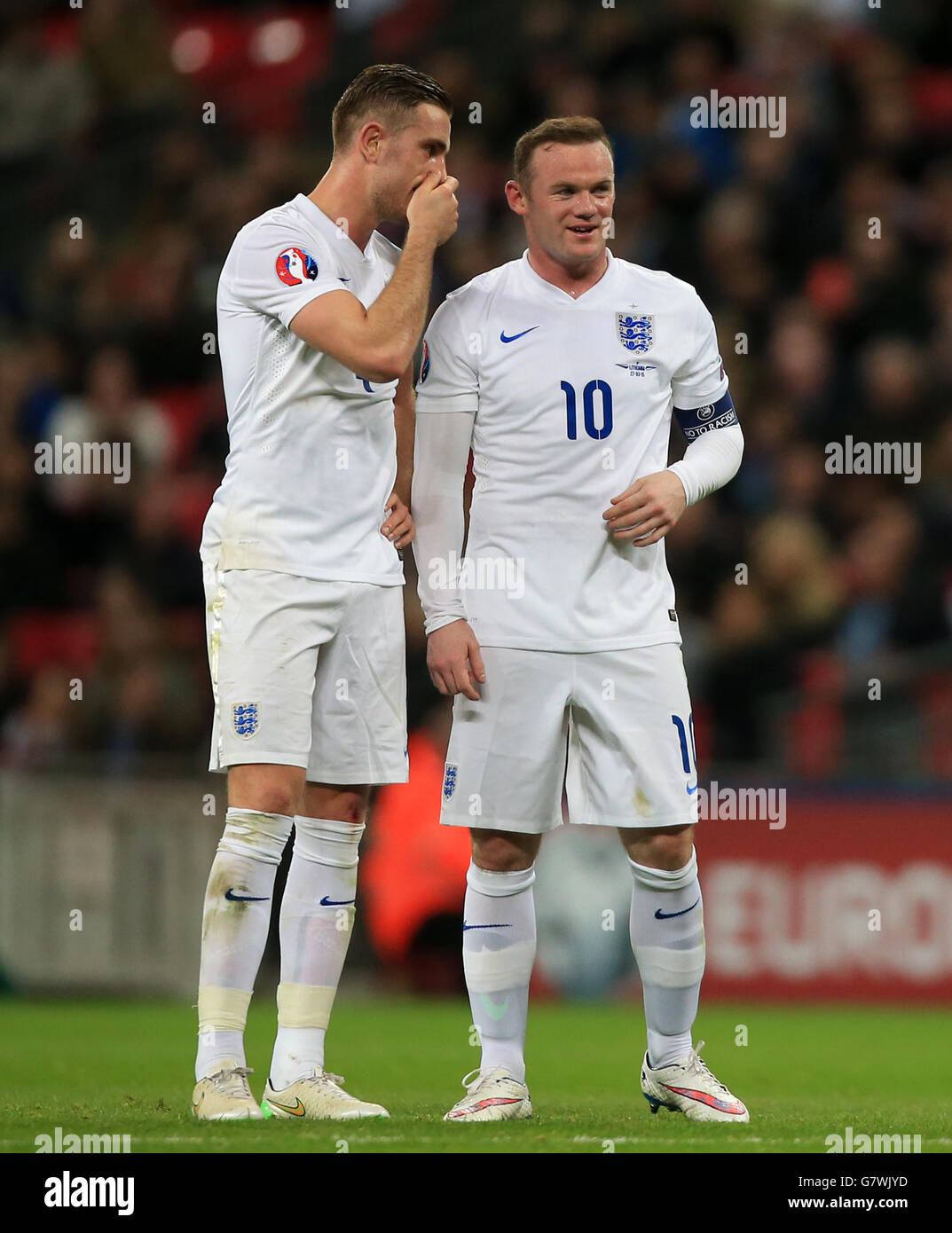 england-s-jordan-henderson-shares-a-joke-with-wayne-rooney-right-stock