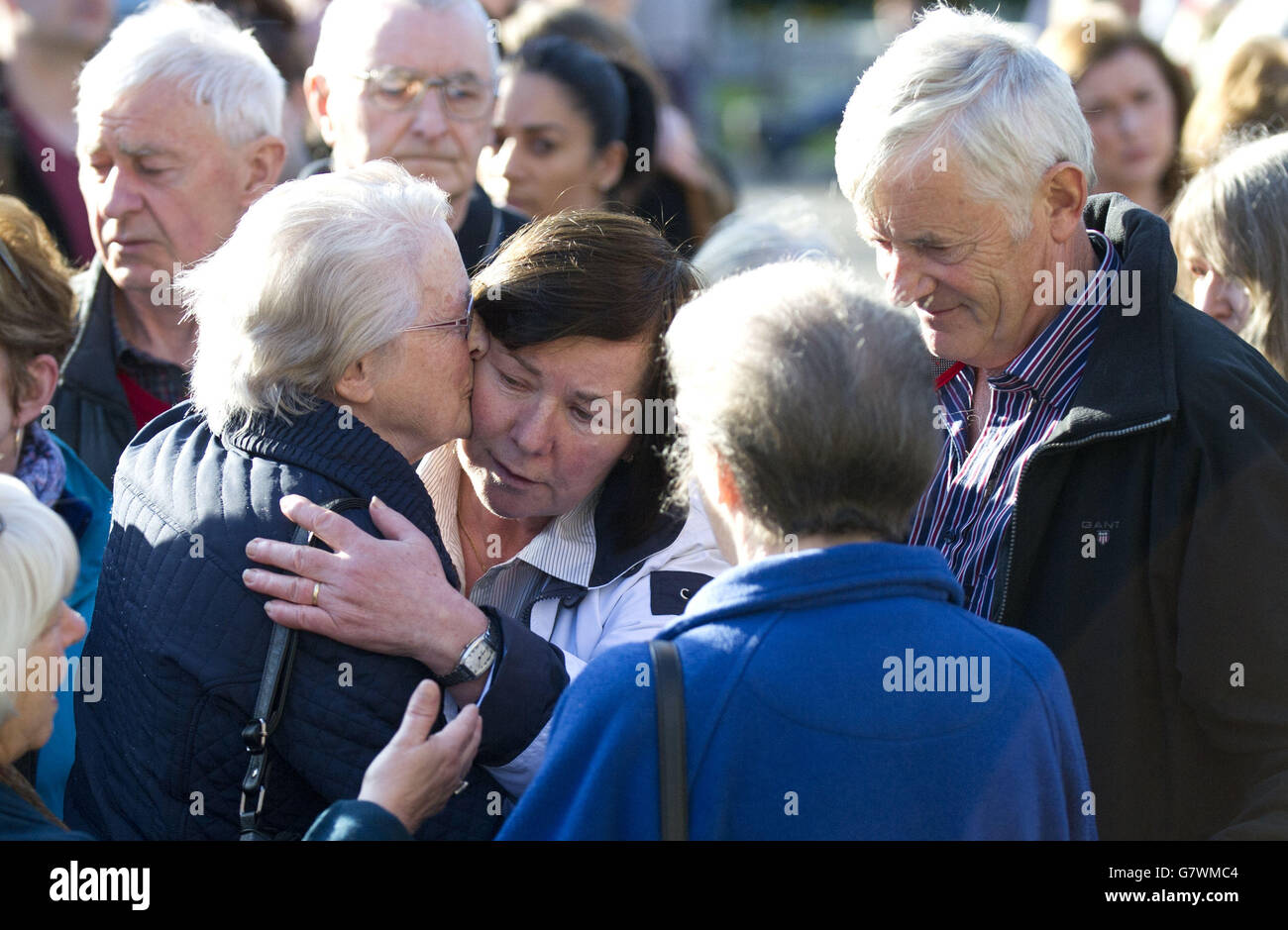 Marian and John Buckley (right and centre), the parents of Karen Buckley, 24, who was found dead on a farm on Wednesday after a four-day police search for her, join hundreds of mourners at a vigil for their daughter in George Square, Glasgow. Stock Photo