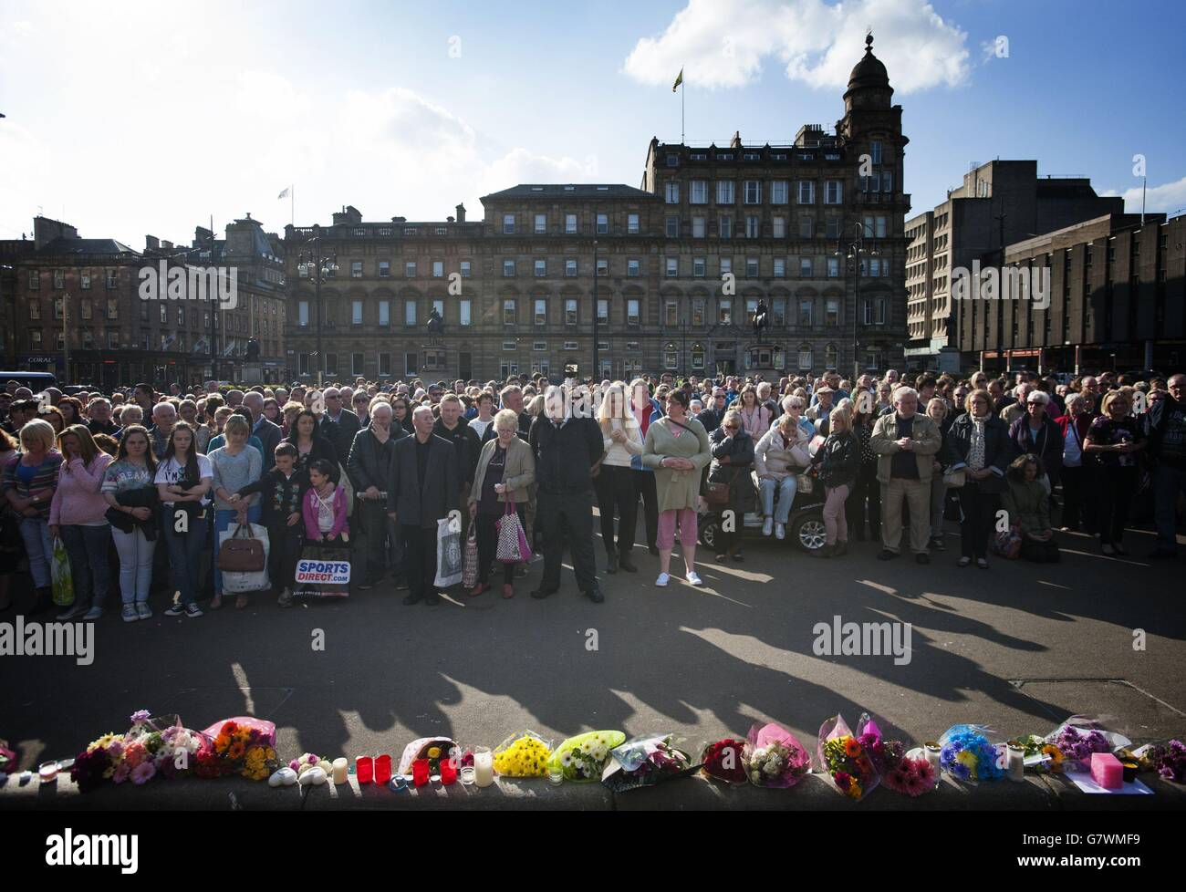 People stand during a vigil in George Square, Glasgow, for Karen Buckley, 24, who was found dead on a farm on Wednesday after a four-day police search. Stock Photo