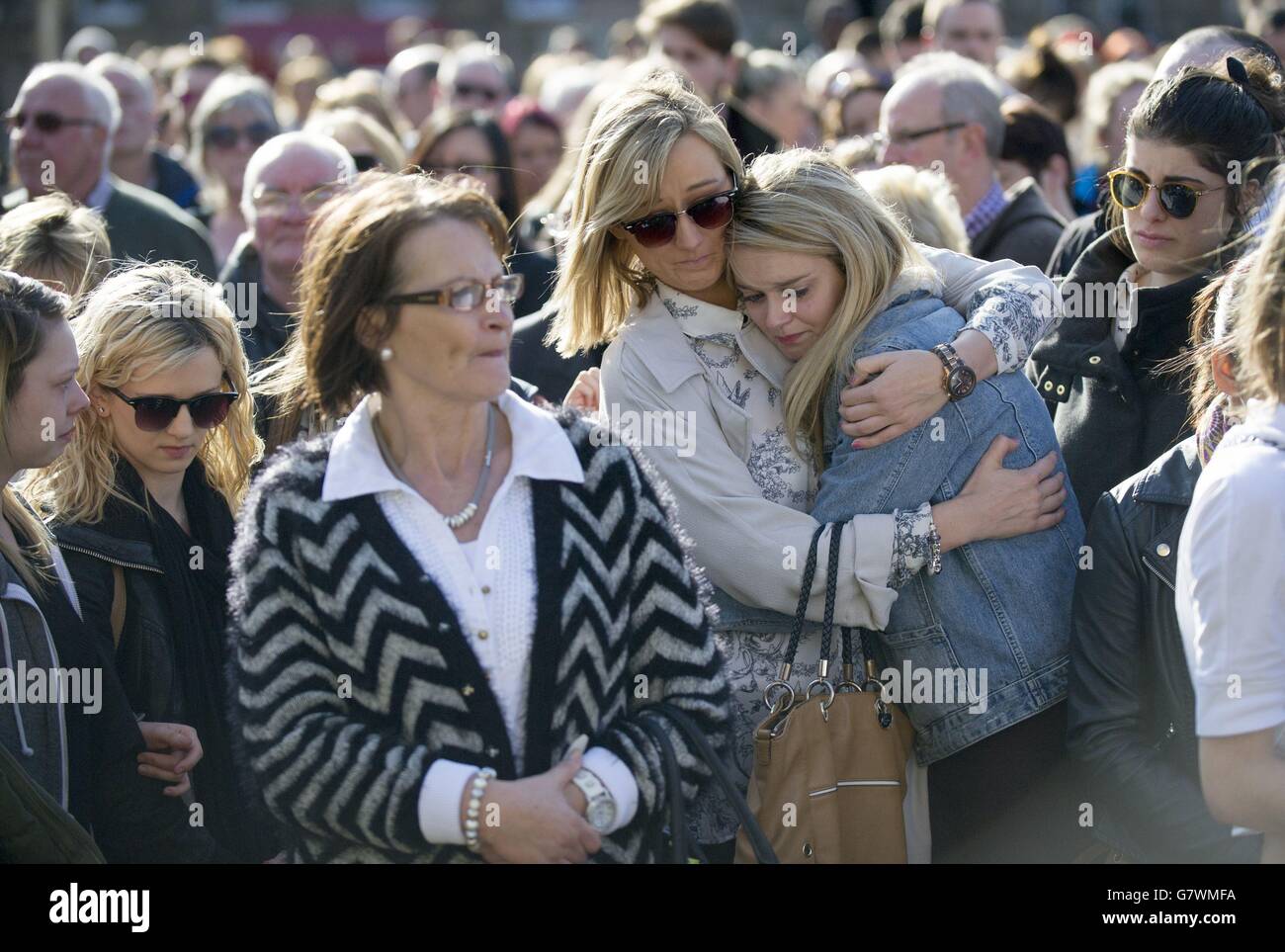 People comfort each other during a vigil in George Square, Glasgow, for Karen Buckley, 24, who was found dead on a farm on Wednesday after a four-day police search. Stock Photo