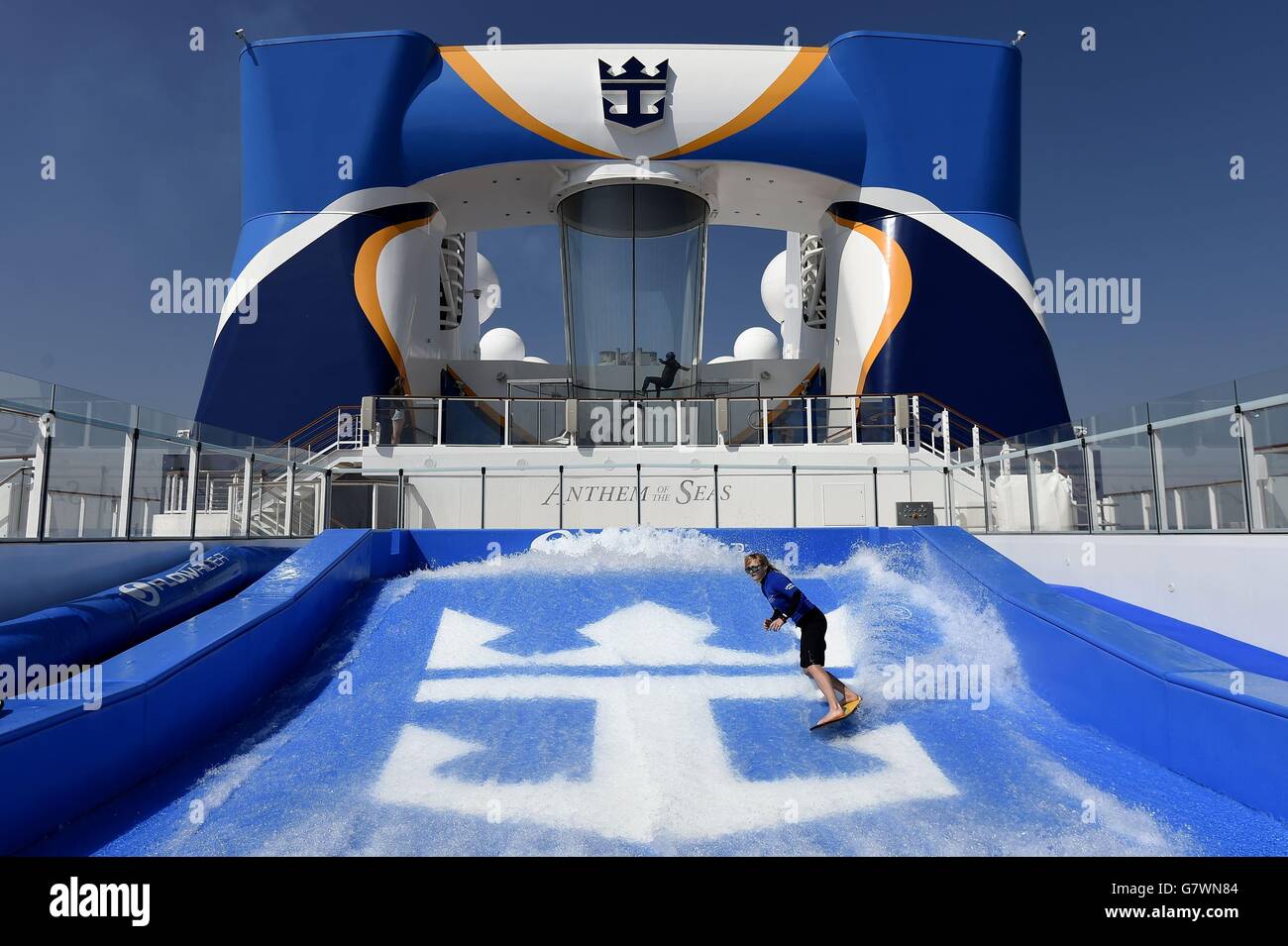 An instructor demonstrates the FlowRider wave machine onboard Royal ...