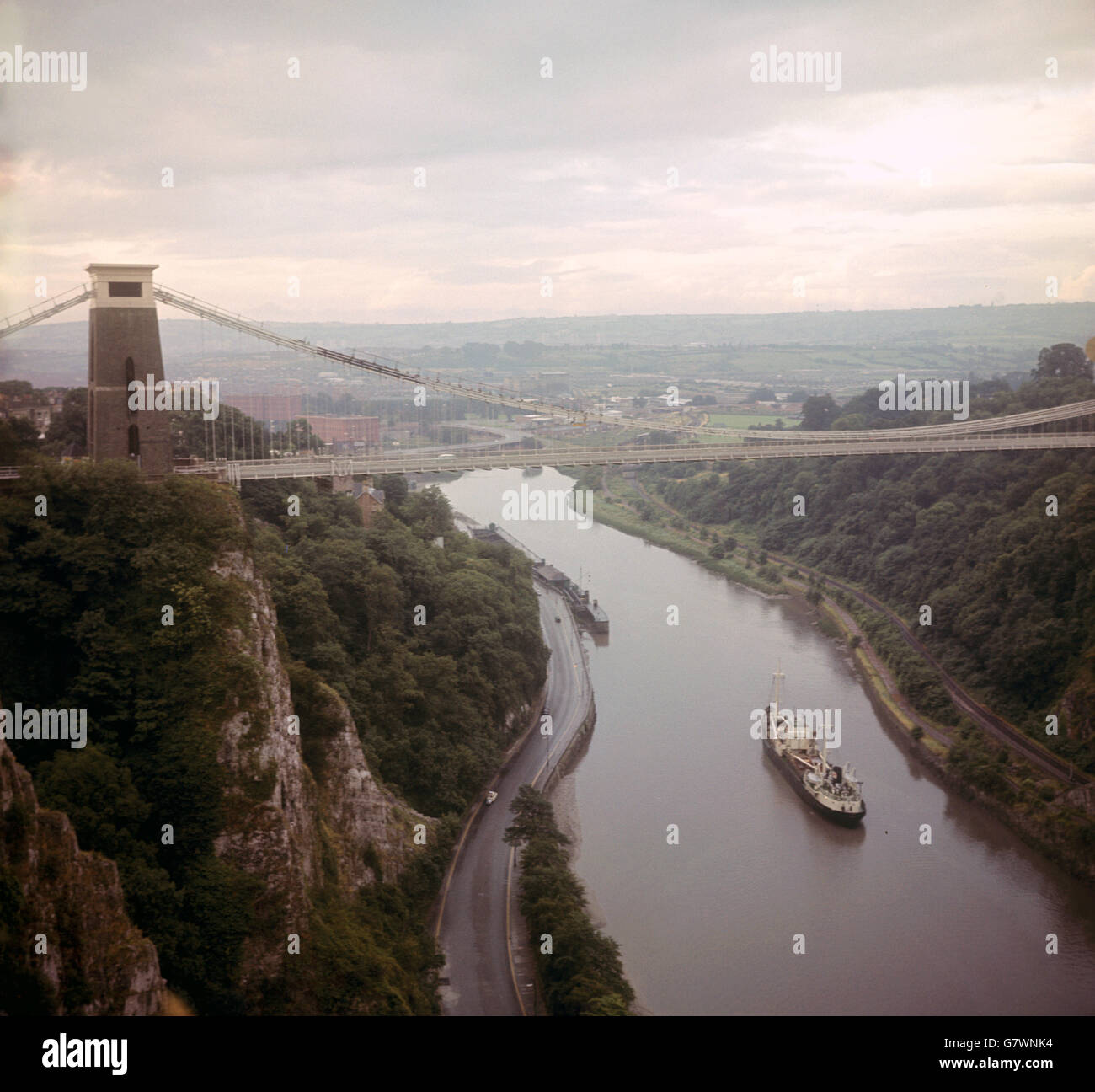 Buildings and Landmarks - Clifton Suspension Bridge - Bristol. A boat passes under the 245ft high Clifton Suspension bridge over the Avon Gorge near Bristol. Stock Photo