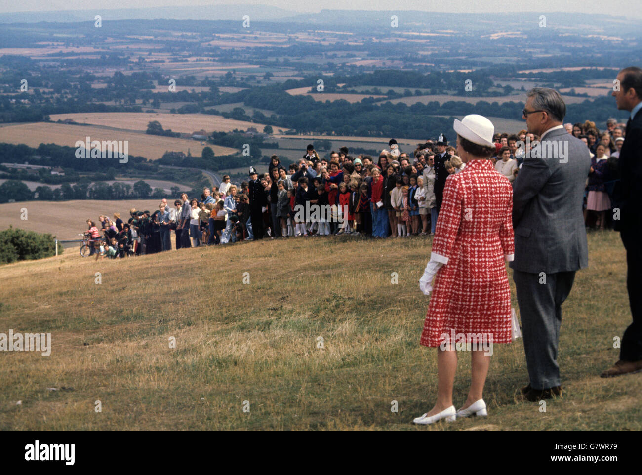 The Queen take sin the view while visiting the Queen Elizabeth Country Park at Butser Hill, Hampshire. Stock Photo
