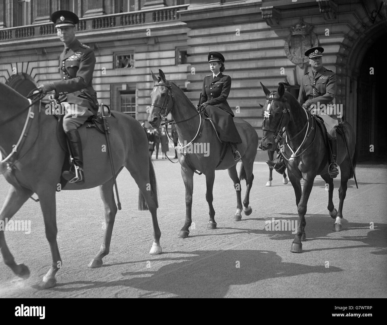 Her royal highness Princess Elizabeth rides side-saddle behind her the father, The King, at her first Trooping of the Colour since she was made Colonel of the Grenadier Guards. Stock Photo