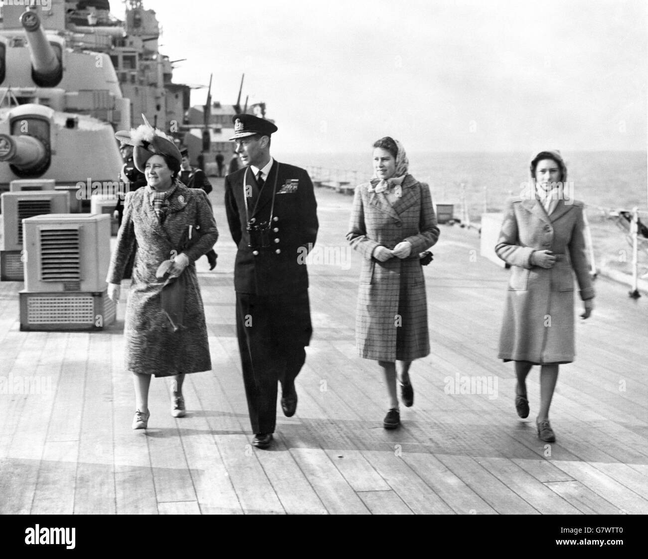 King George VI and Queen Elizabeth pictured with the Princesses, Elizabeth and Margaret, on deck on HMS Vanguard as they head for South Africa. Stock Photo
