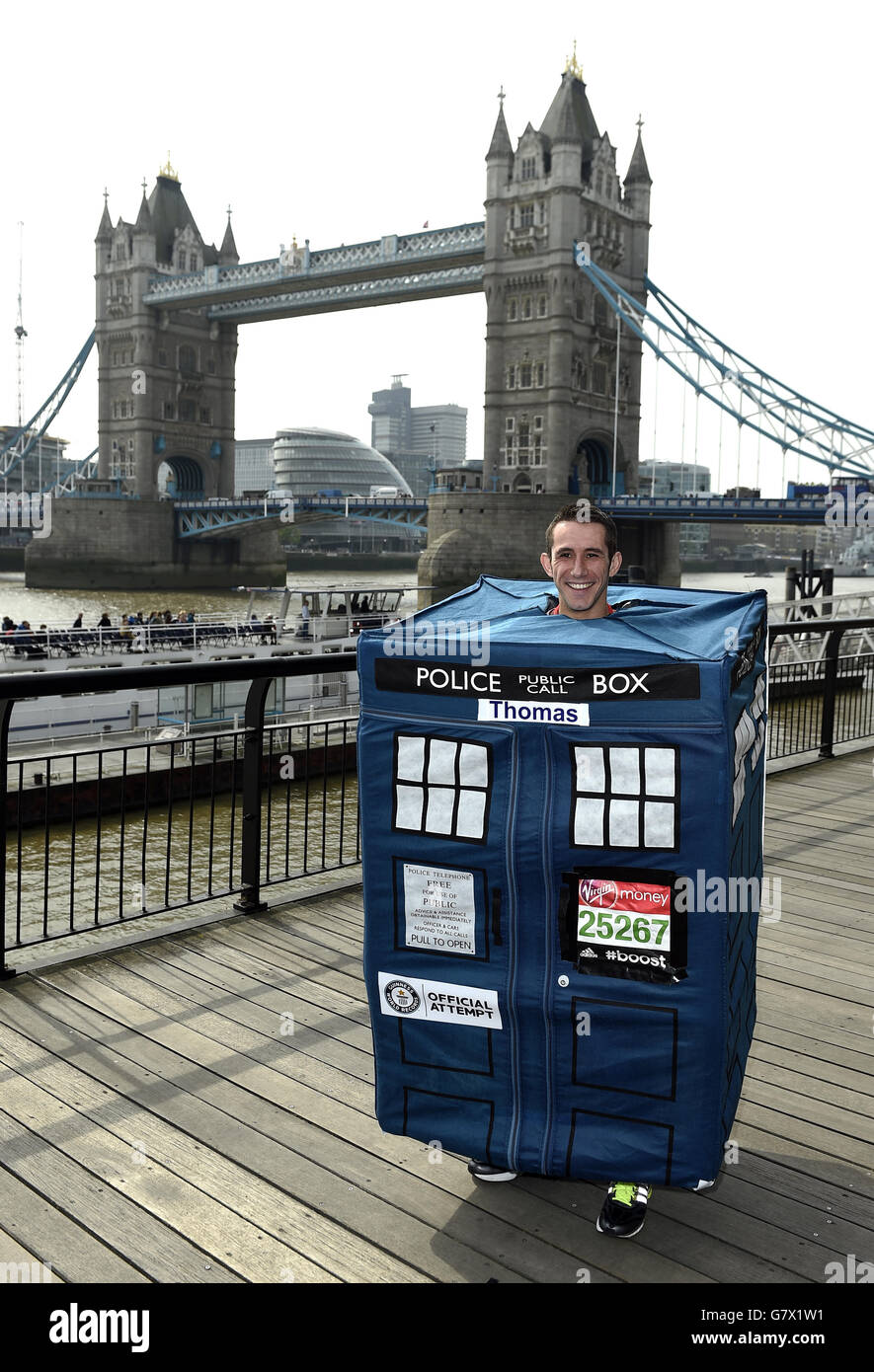 Thomas Bolton from Loughborough, who is attempting to run the London marathon as the fastest person dressed as a telephone box, poses for a photograph during a photocall ahead of the Virgin Money London Marathon 2015 at the Tower Hotel, London. Stock Photo