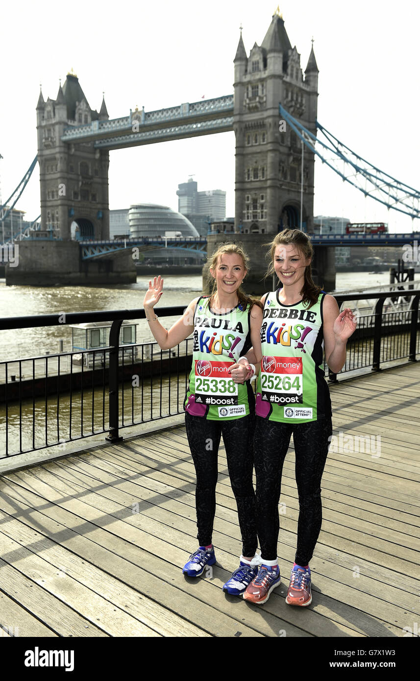 Debbie Leeland (right) and Paula Marshall from Yateley and Billinghurt respectively, who are attempting to run the London marathon as the fastest marathon three legged (female), pose for a photograph during a photocall ahead of the Virgin Money London Marathon 2015 at the Tower Hotel, London. Stock Photo