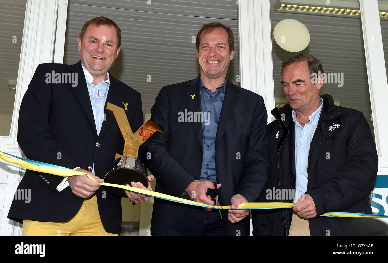 Christian Prudhomme (centre) Director of Tour de France with Gary Verity (left), Chief Executive of Welcome to Yorkshire and Bernard Hinault (Right), 5 times winner of the Tour de France look at the trophy during a photocall at York racecourse, ahead of the Tour de Yorkshire which starts tomorrow. Stock Photo