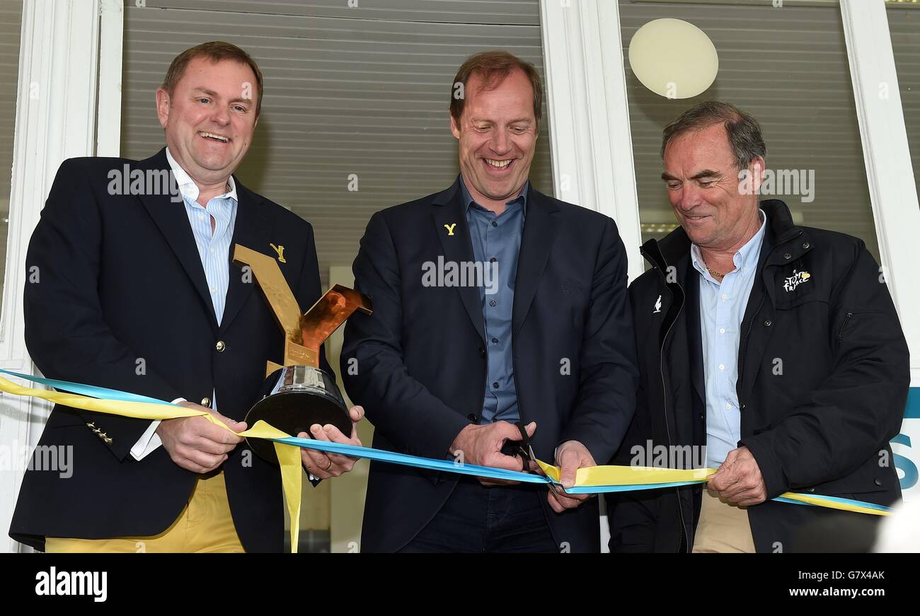 Christian Prudhomme (centre) Director of Tour de France cuts the ribbon with Gary Verity (left), Chief Executive of Welcome to Yorkshire and Bernard Hinault (Right), 5 times winner of the Tour de France during a photocall at York racecourse, ahead of the Tour de Yorkshire which starts tomorrow. Stock Photo