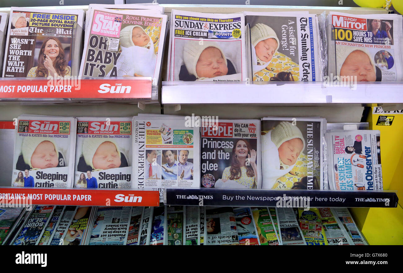 Newspapers on sale in a shop in Ashford, Kent, as the newest member of Britain's royal family unsurprisingly dominates the newspaper headlines. Stock Photo