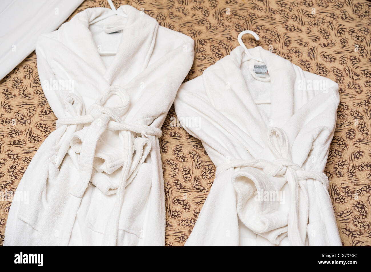 Bathing robes on hotel bed. For spa and relaxation concepts. Stock Photo