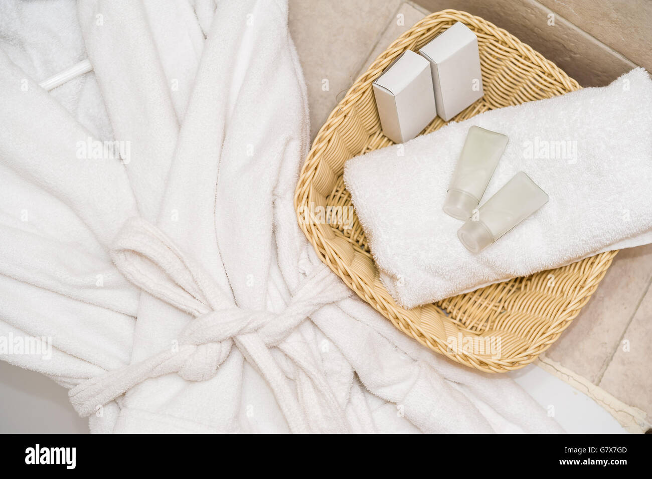 Top view of bathing robe with spa and wellness objects in basket. Stock Photo