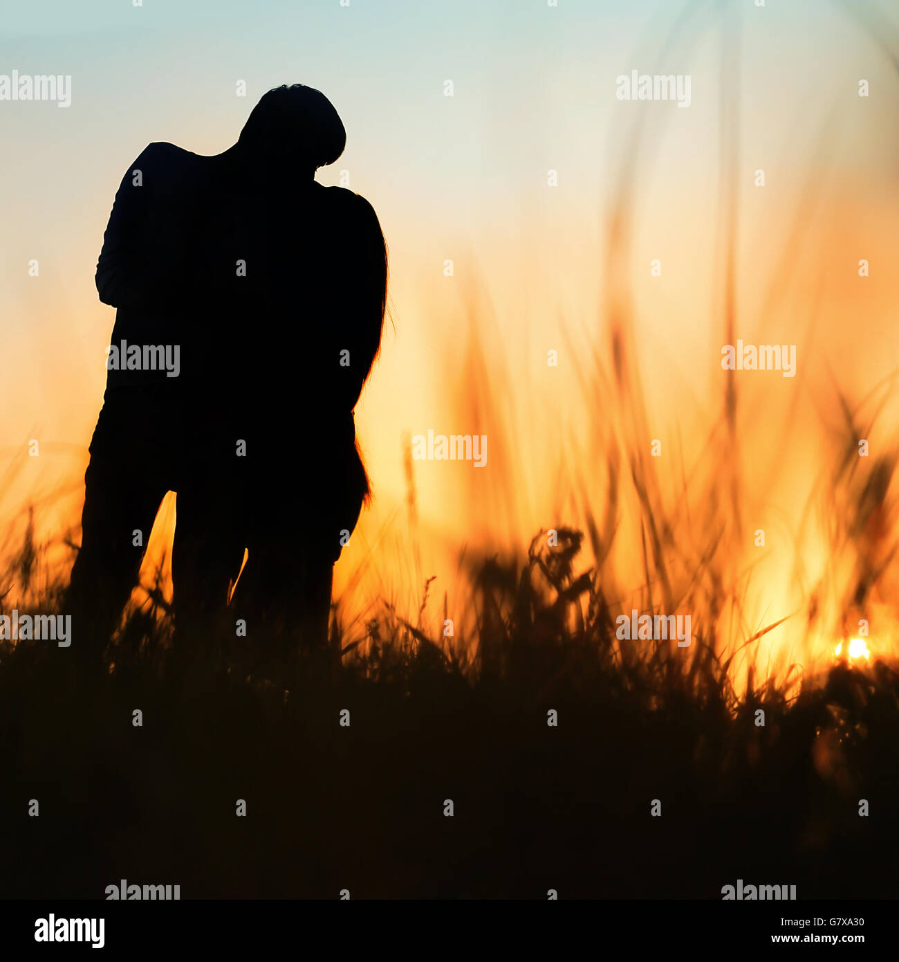 silhouette of a young couple kissing at sunset Stock Photo - Alamy
