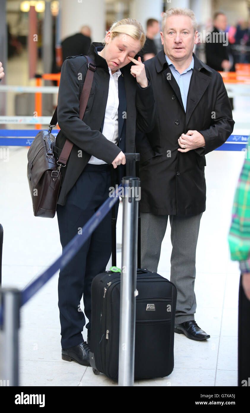 SNP's Mhairi Black MP the 20-year-old who ousted Labour frontbencher Douglas Alexander in the recent General Election arrives at Glasgow Airport with her father Alan as she joins other new SNP MPs as they travel to Westminster in London. Stock Photo