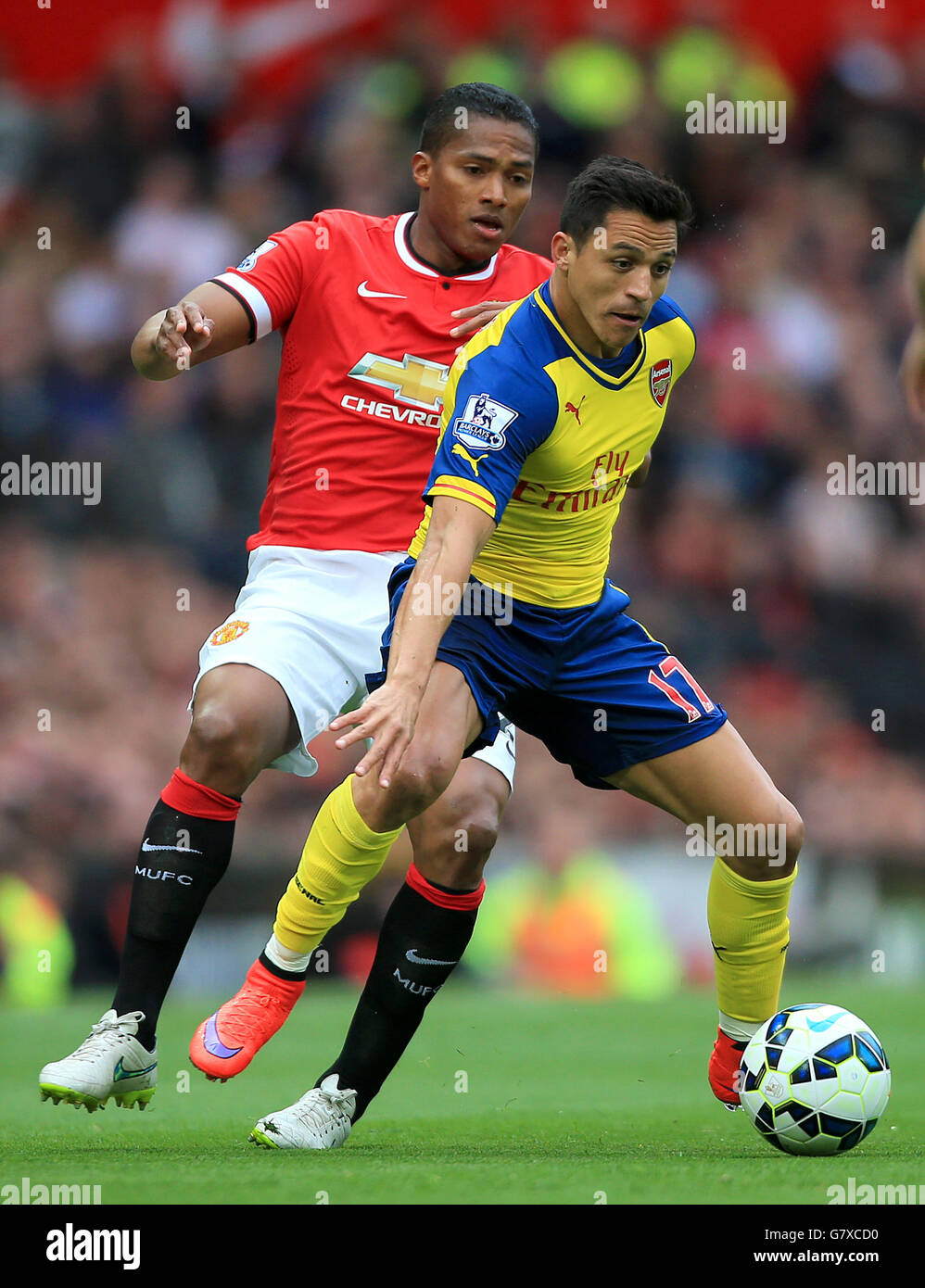 Manchester United's Luis Antonio Valencia (left) and Arsenal's Alexis Sanchez in action during the Barclays Premier League match at Old Trafford, Manchester. PRESS ASSOCIATION Photo. Picture date: Sunday May 17, 2015. See PA story SOCCER Man Utd. Photo credit should read: Nick Potts/PA Wire. Stock Photo