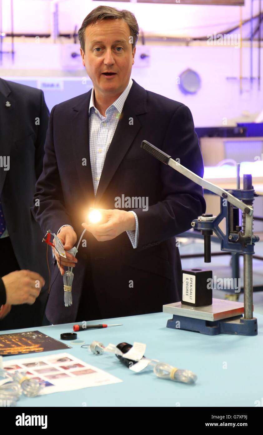 Prime Minister David Cameron tests a light bulb during a visit to ACDC Lighting in Barrowford, Pendle. Stock Photo