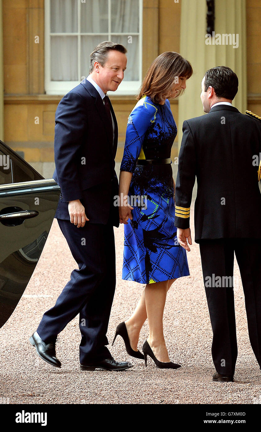 Prime Minister David Cameron (left) arrives at Buckingham Palace, London with his wfe Samantha, for an audience with the Queen to confirm his second term as Prime Minister following his party's General Election victory. Stock Photo