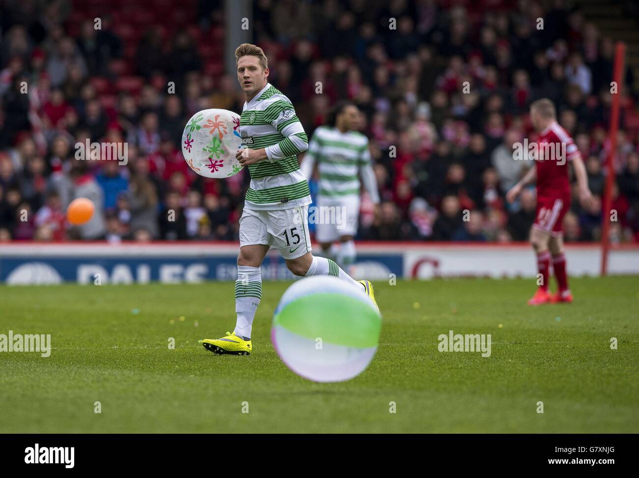 Celtics Kris Comons clears a beachball from the pitch during the Scottish Premiership match at Pittodrie Stadium, Aberdeen. Stock Photo