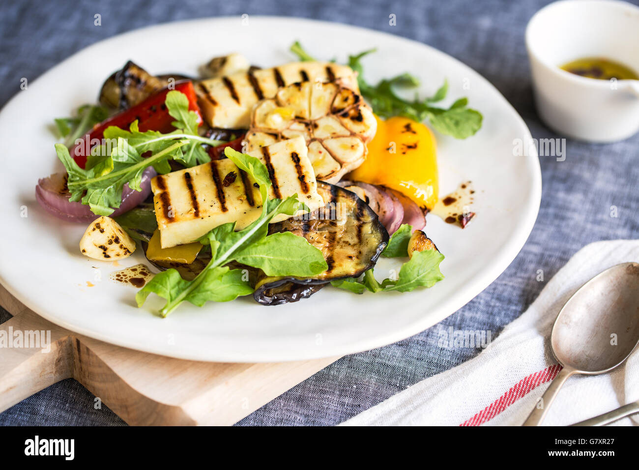 Grilled Halloumi with aubergine,pepper garlic and rocket salad Stock Photo