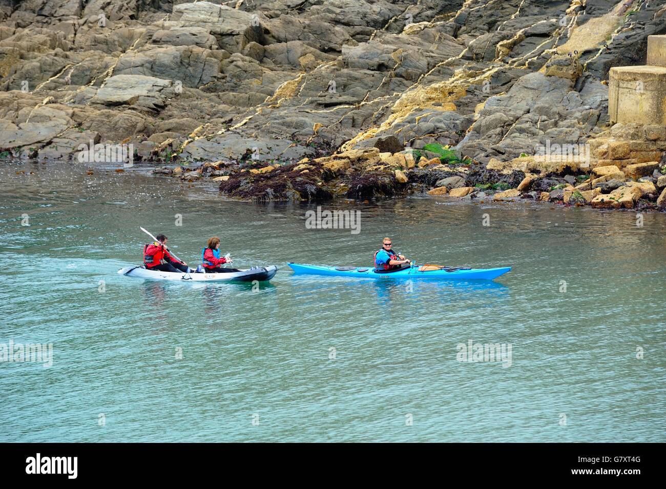 people kayaking into Porthleven harbour Cornwall England UK Stock Photo
