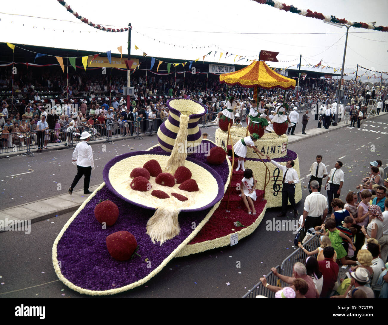 Battle of the Flowers - Jersey. The Parish of St Martin exhibit their 'Strawberry Fayre' float at Jersey's Battle of the Flowers. Stock Photo