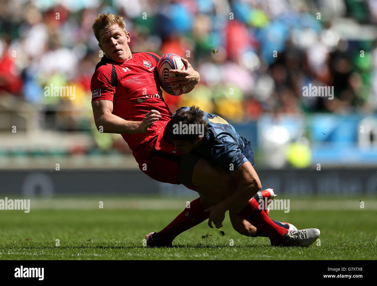 Canada's John Moonlight is tackled by Argentina's Rodrigo Etchart in the Pool A match during the Marriott London Sevens at Twickenham Stadium, London. PRESS ASSOCIAION Photo. Picture date: Saturday May 16, 2015. See PA story RUGBYU London. Photo credit should read: Steven Paston/PA Wire Stock Photo