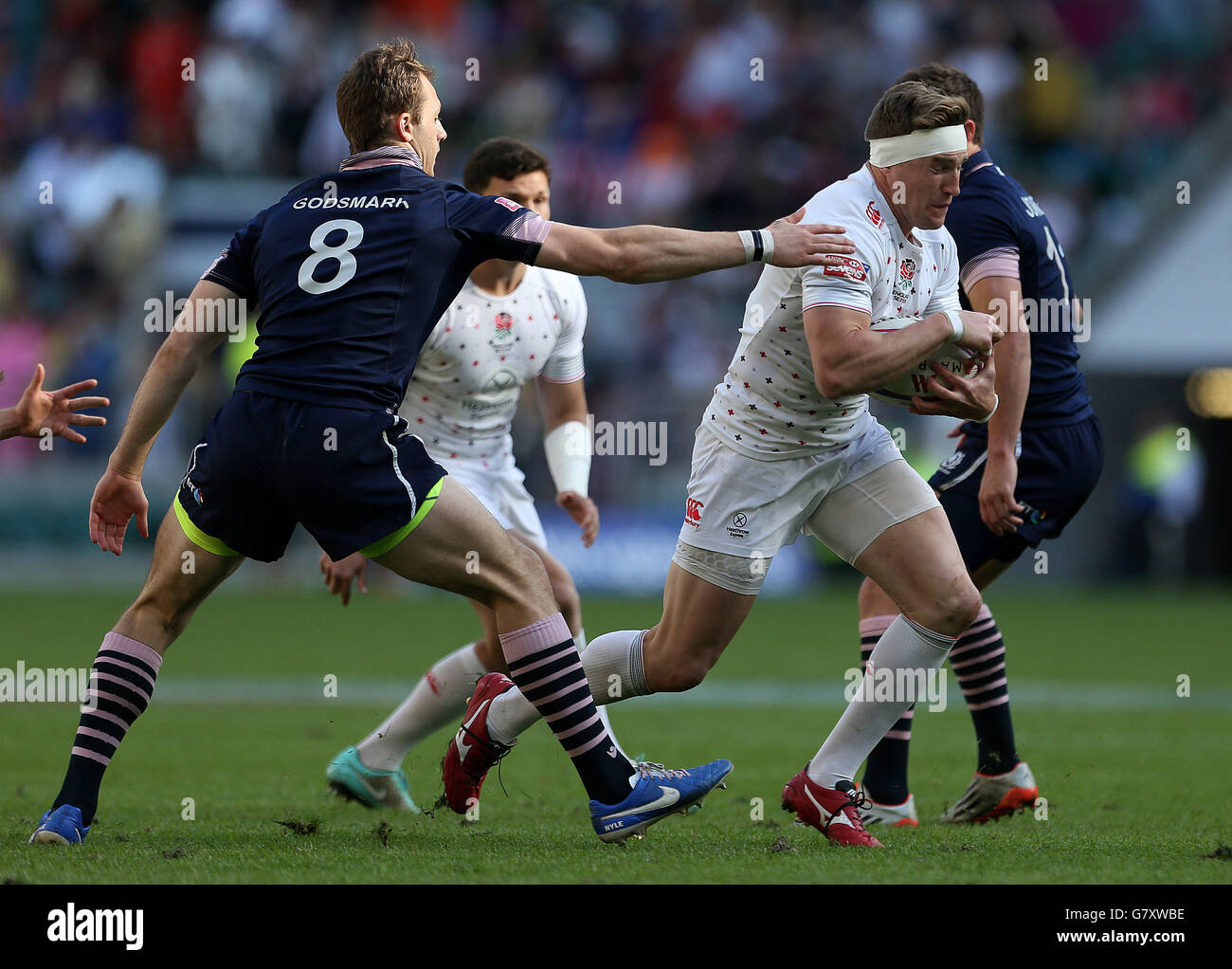 England's Phil Burgess is tackled by Scotland's Nyle Godsmark in the Pool C match during the Marriott London Sevens at Twickenham Stadium, London. PRESS ASSOCIAION Photo. Picture date: Saturday May 16, 2015. See PA story RUGBYU London. Photo credit should read: Steven Paston/PA Wire Stock Photo