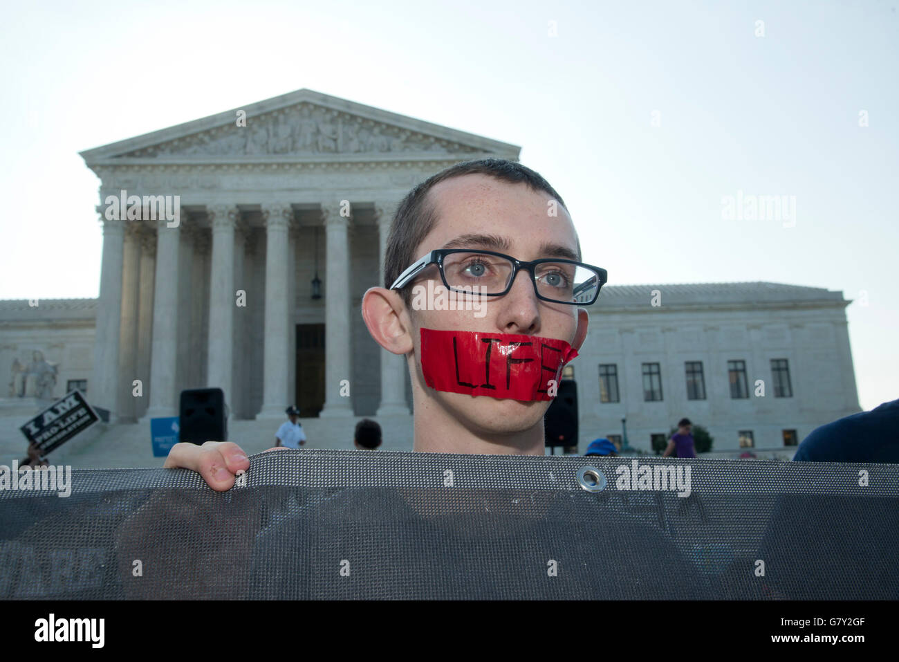 Washington DC, USA. 27th June, 2016. USA-Ryan Orr, a 17 year old pro-life protester stands at the Supreme Court.  Pro-Life and Pro-Choice advocates protest at the Supreme Court in Washington DC in anticipation of the Supreme Court 's ruling on free access to abortion.  The Supreme Court ruled 5-3 to abolish Texas's abortion laws for clinics. Credit:  Patsy Lynch/Alamy Live News Stock Photo