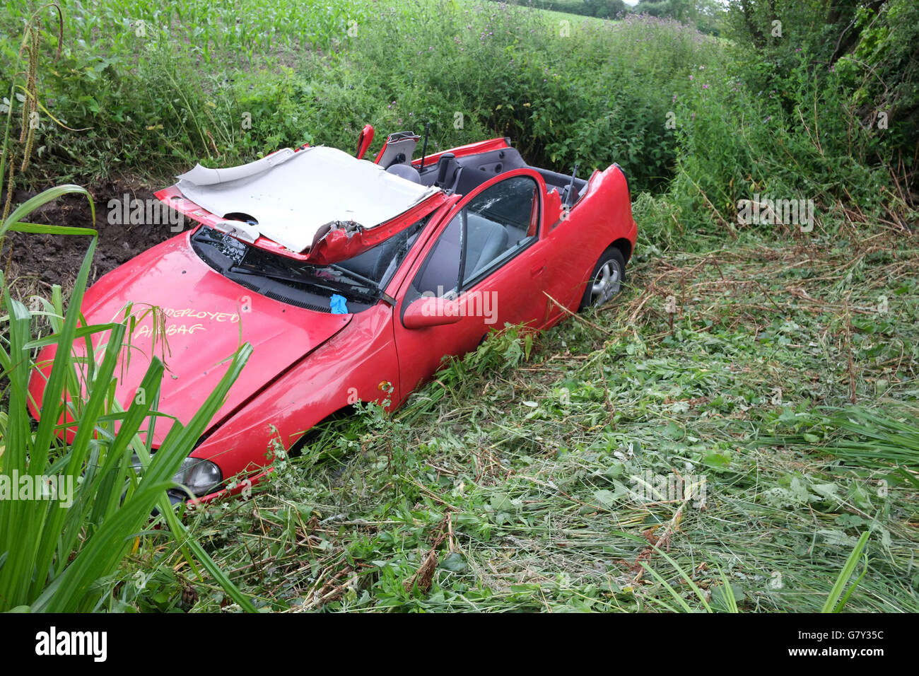 West Rolstone Road, Somerset, UK. 27th June, 2016. Vauxhall - Opel Tigra crashed into a ditch in rural Somerset, with the roof cut off be emergency services to rescue the driver. West Rolstone Road, Somerset Credit:  Timothy Large/Alamy Live News Stock Photo