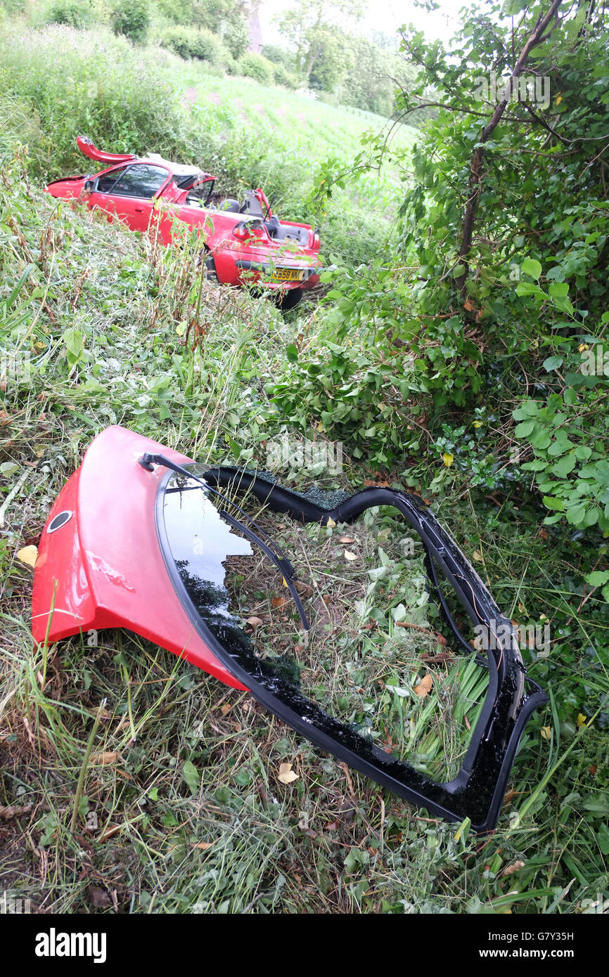 West Rolstone Road, Somerset, UK. 27th June, 2016. Vauxhall - Opel Tigra crashed into a ditch in rural Somerset, with the roof cut off be emergency services to rescue the driver. West Rolstone Road, Somerset Credit:  Timothy Large/Alamy Live News Stock Photo
