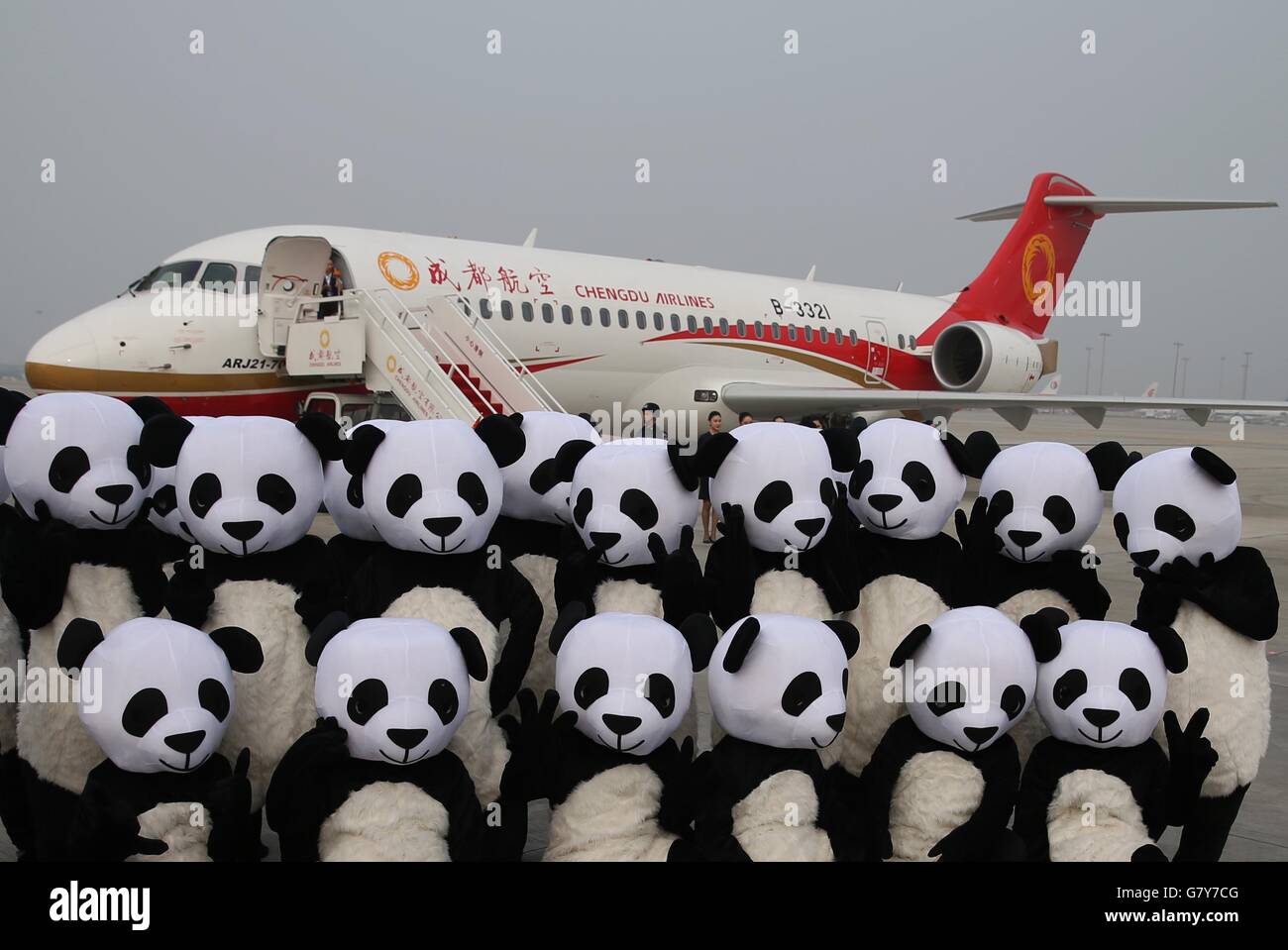 Chengdu, China's Sichuan Province. 28th June, 2016. Panda mascots pose for a photo in front of Chengdu Airlines' ARJ21-700 in Chengdu Shuangliu International Airport in Chengdu, capital of southwest China's Sichuan Province, June 28, 2016. ARJ21, manufactured by the Commercial Aircraft Corp. of China (COMAC), made its maiden commercial flight from Chengdu to Shanghai Tuesday. The domestically-designed airliner is China's first regional jet manufactured according to international standards. © Ding Ting/Xinhua/Alamy Live News Stock Photo