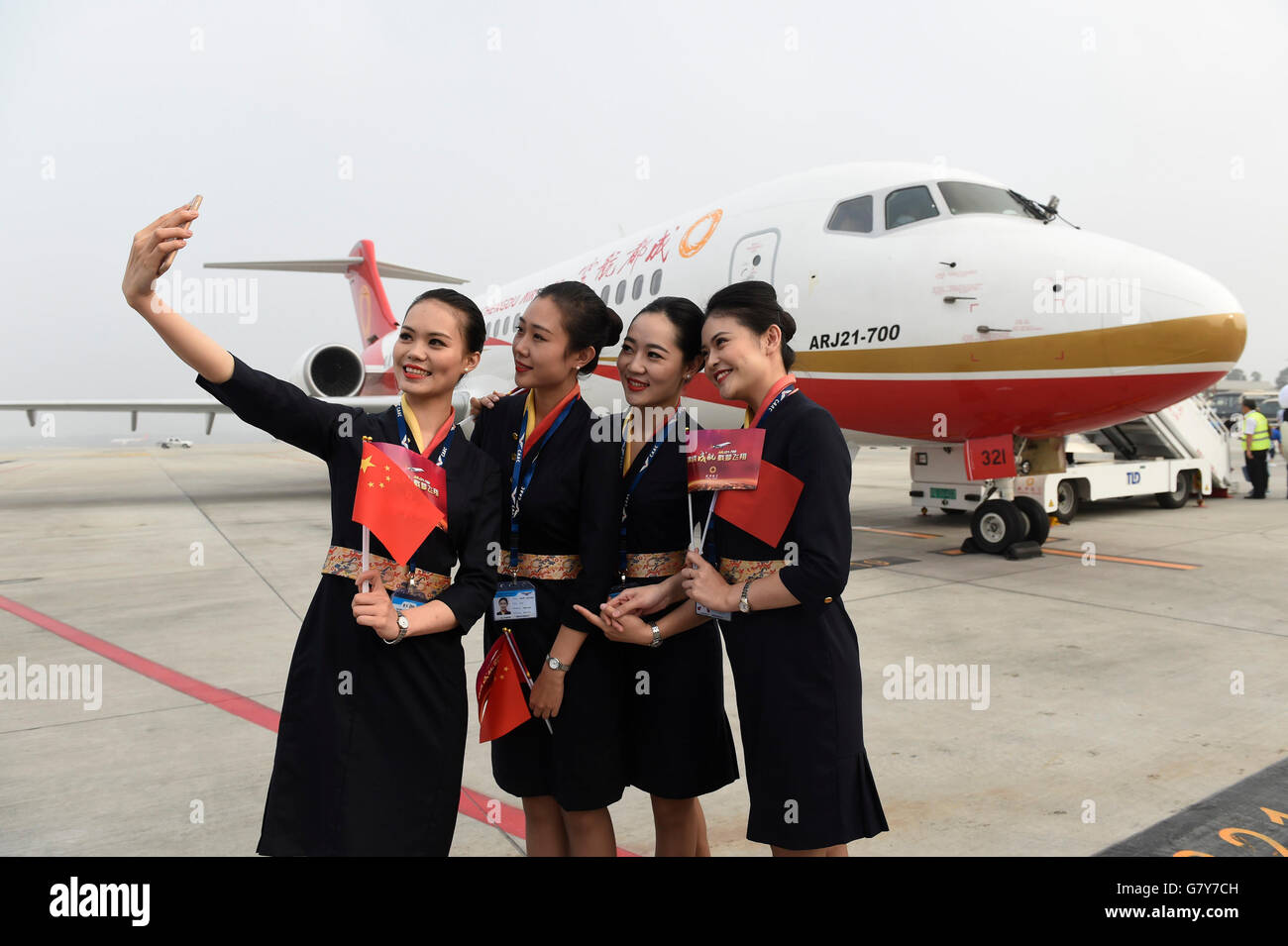Chengdu, China's Sichuan Province. 28th June, 2016. Stewardesses pose for a photo in front of Chengdu Airlines' ARJ21 in Chengdu Shuangliu International Airport in Chengdu, capital of southwest China's Sichuan Province, June 28, 2016. ARJ21, manufactured by the Commercial Aircraft Corp. of China (COMAC), made its maiden commercial flight from Chengdu to Shanghai Tuesday. The domestically-designed airliner is China's first regional jet manufactured according to international standards. © Liu Kun/Xinhua/Alamy Live News Stock Photo