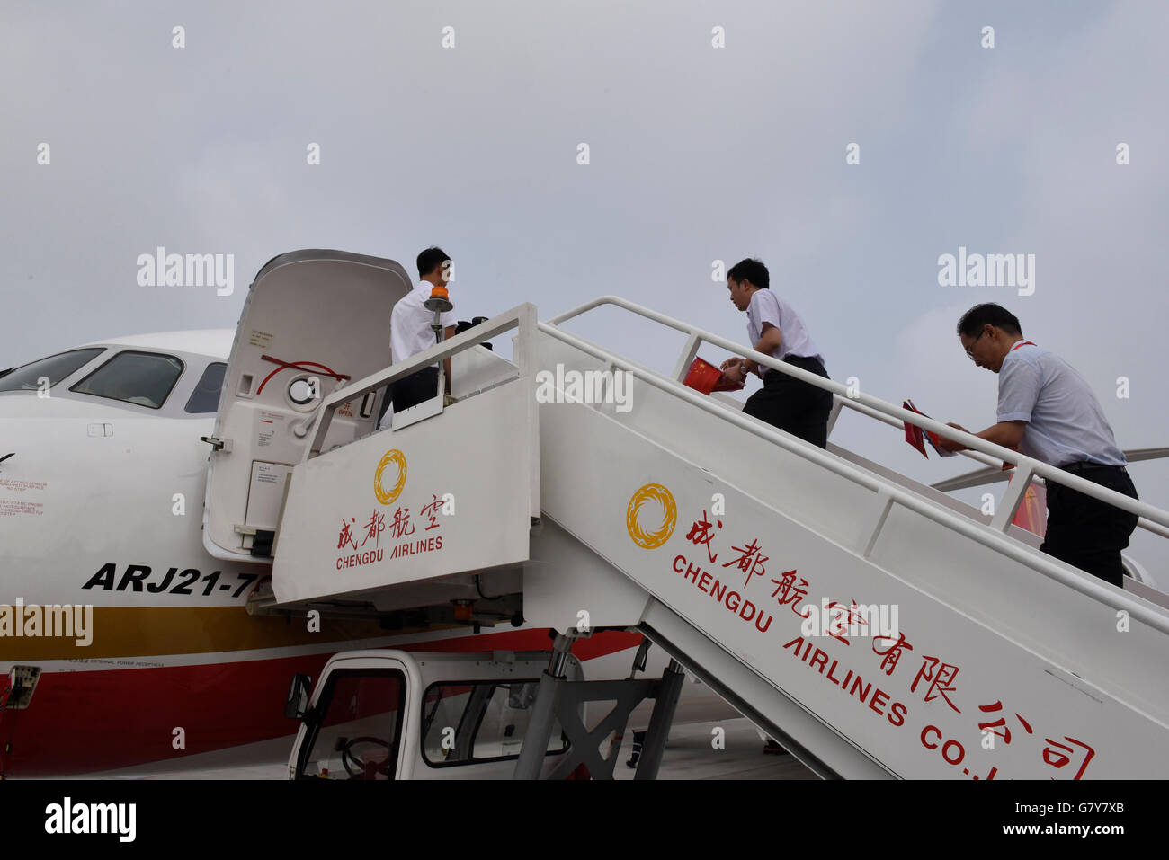 Chengdu, China's Sichuan Province. 28th June, 2016. Passengers board Chengdu Airlines ARJ21-700 at Shuangliu International Airport in Chengdu, capital of southwest China's Sichuan Province, June 28, 2016. ARJ21, manufactured by the Commercial Aircraft Corp. of China (COMAC), made its maiden commercial flight from Chengdu to Shanghai Tuesday. The domestically-designed airliner is China's first regional jet manufactured according to international standards. © Liu Kun/Xinhua/Alamy Live News Stock Photo
